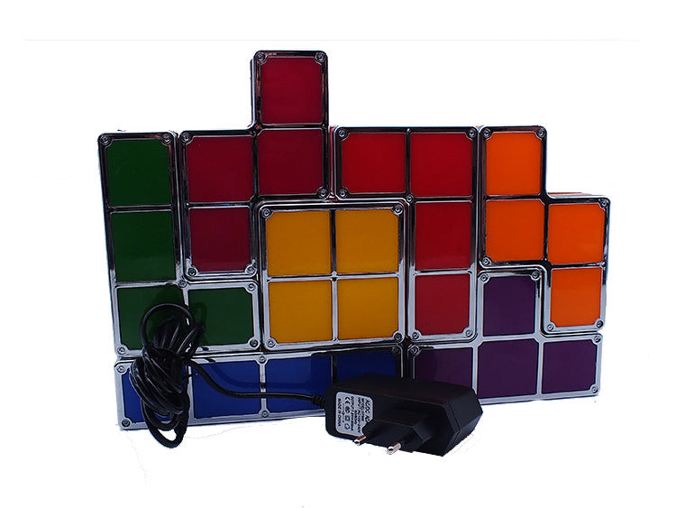 Colorful LED light panel with power adapter on a white background