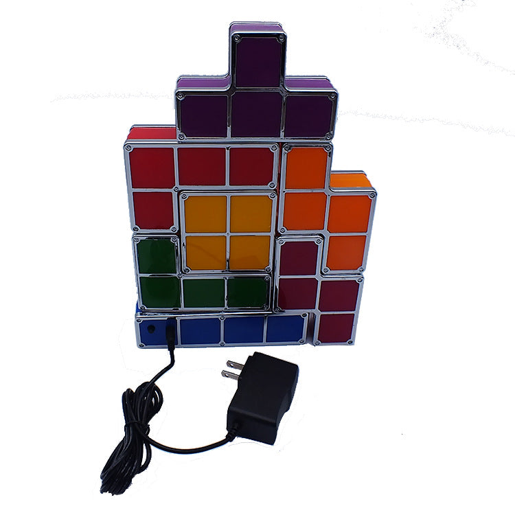 Colorful block-style lamp with power adapter on a white background