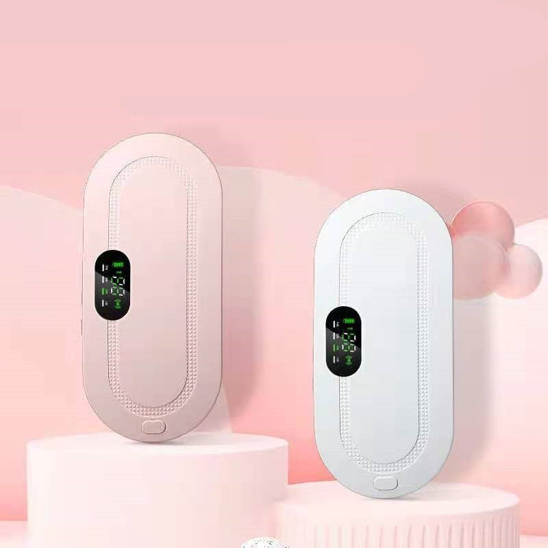 Two electronic menstrual heating pads are shown side by side on pink display pedestals. One device is a soft blush pink, and the other is white, both with oval digital screens.